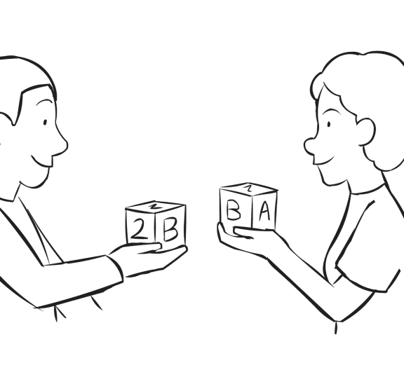 Two people showing a wooden block they are holding and sharing as part of fun ice-breaker called Mingle and Match